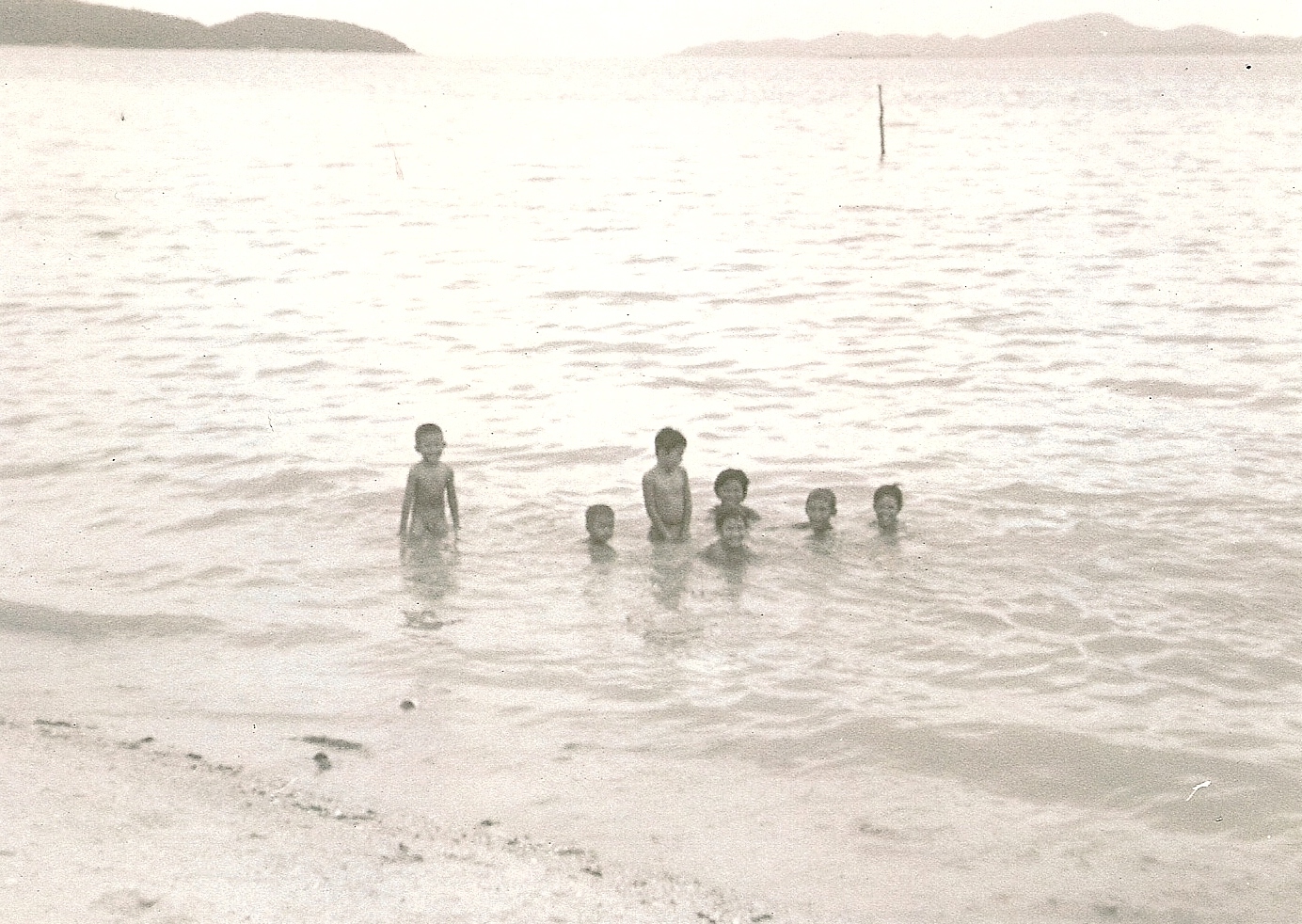 Little boys playing in the water at Pattaya Beach.